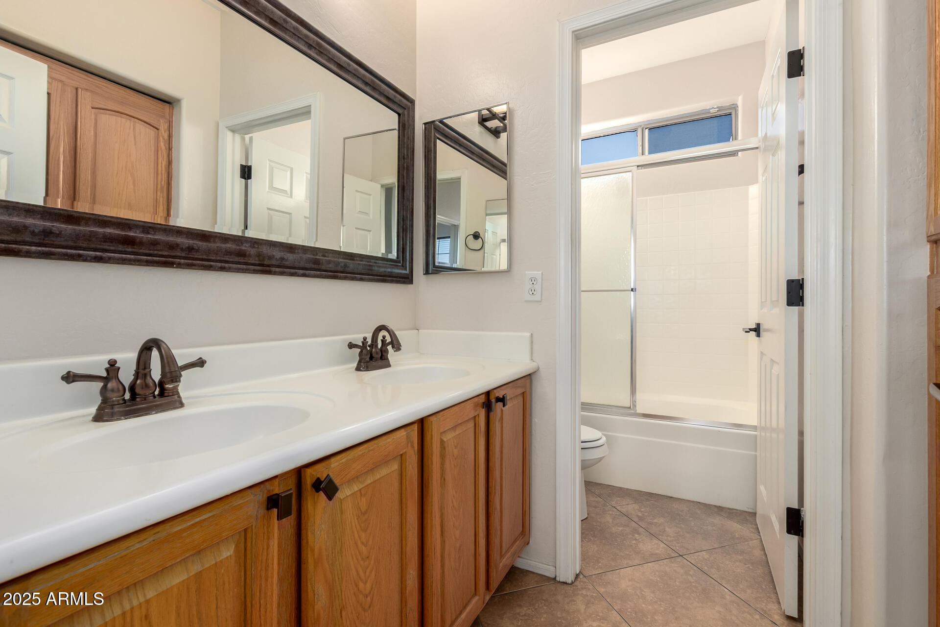 17441 West Arroyo Way Goodyear, AZ 85338 - Photo 24 of 27 a bathroom with a sink a toilet and a mirror