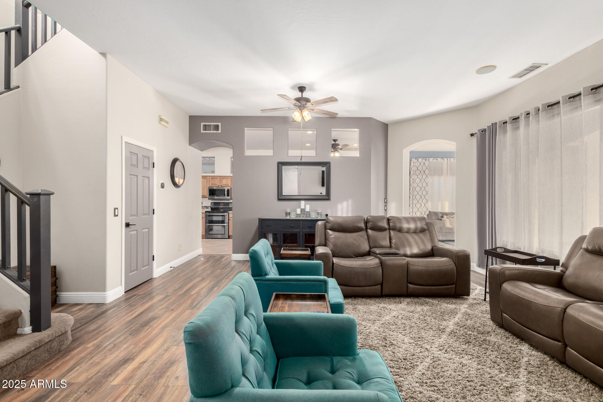 17441 West Arroyo Way Goodyear, AZ 85338 - Photo 3 of 27 a living room with furniture ceiling fan and a rug