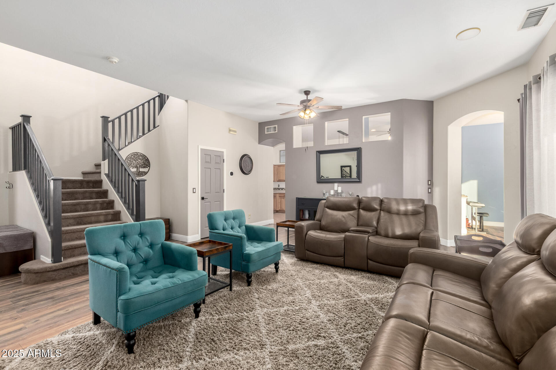 17441 West Arroyo Way Goodyear, AZ 85338 - Photo 4 of 27 a living room with furniture and a chandelier