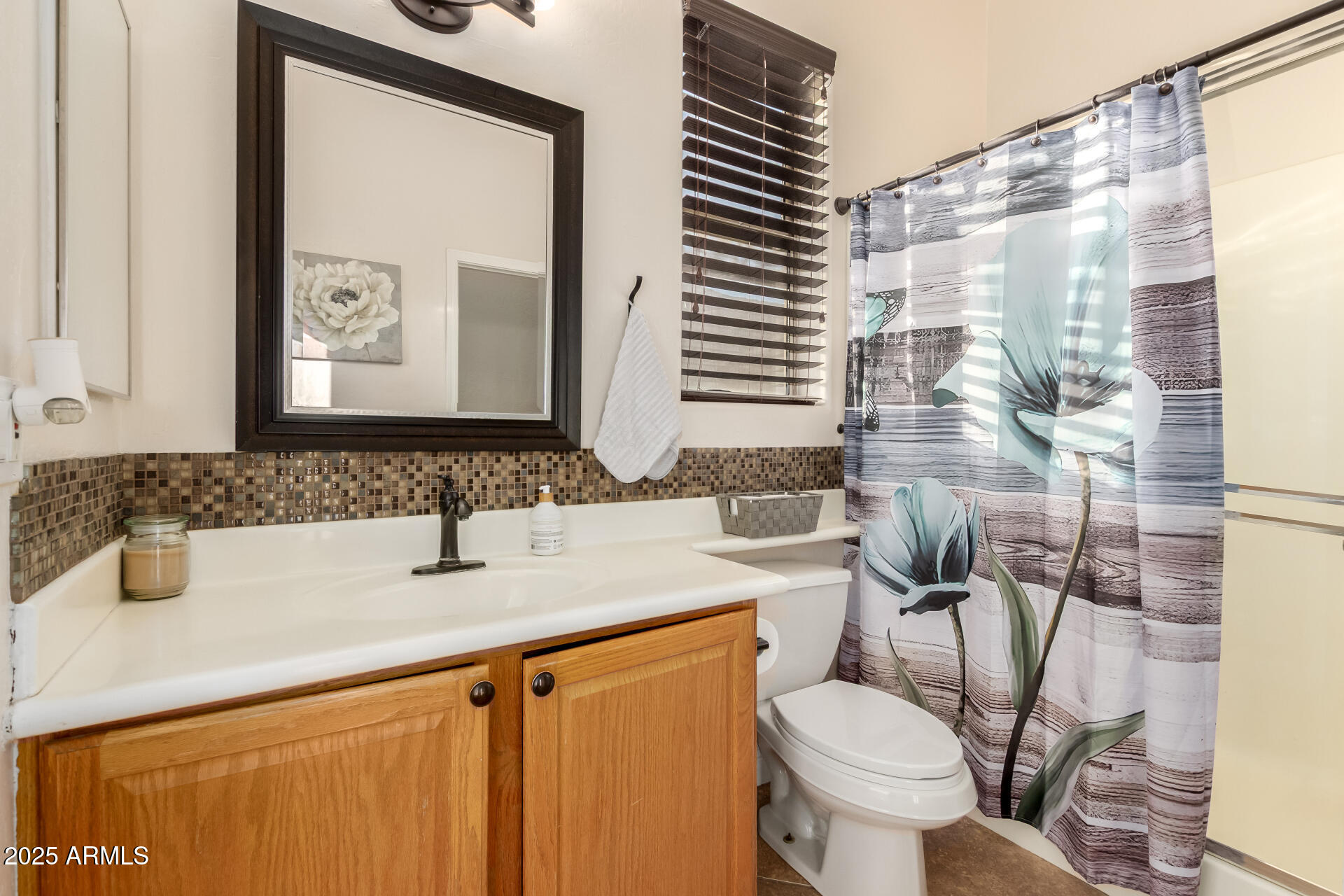 17441 West Arroyo Way Goodyear, AZ 85338 - Photo 7 of 27 a bathroom with a sink toilet and shower