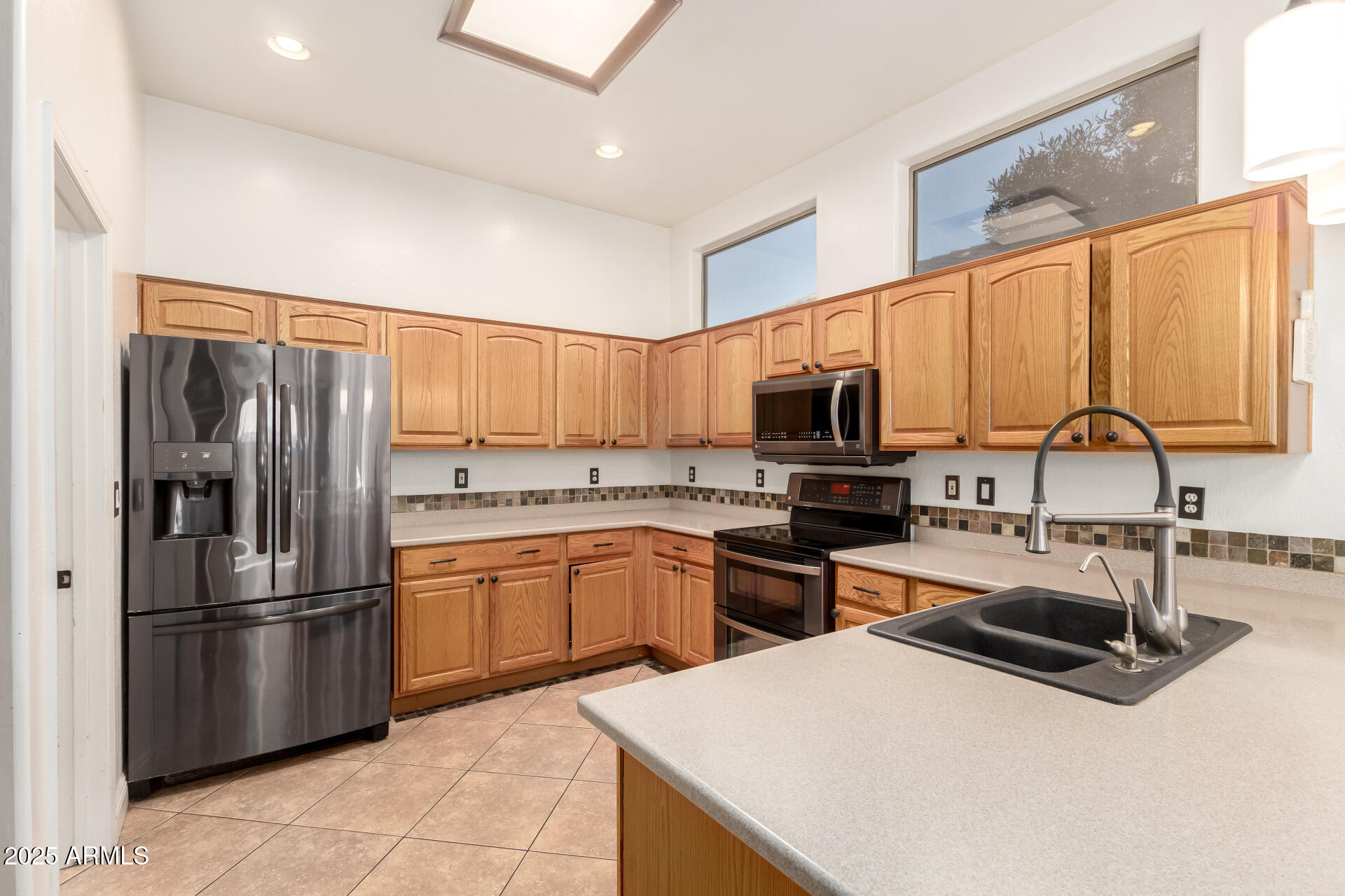 17441 West Arroyo Way Goodyear, AZ 85338 - Photo 10 of 27 a kitchen with stainless steel appliances granite countertop a sink stove and refrigerator