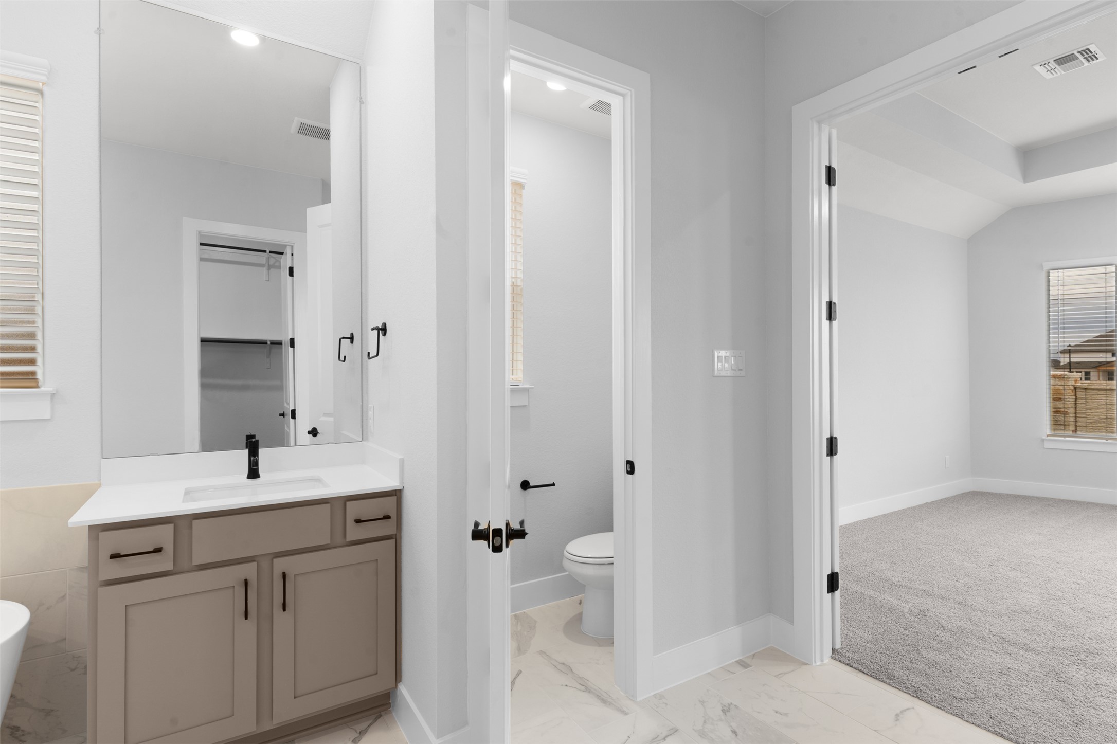 17308 Hope Bergman Road Pflugerville, TX 78660 - Photo 23 of 39 Full bath with vanity, light marble finish flooring, and a freestanding bath