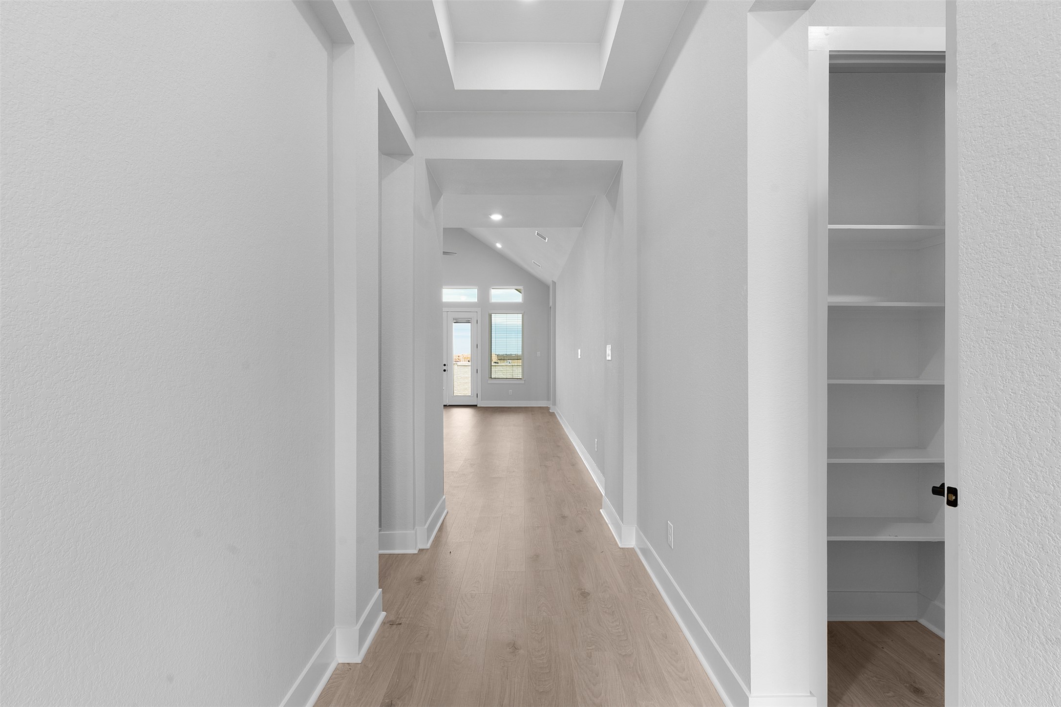 17308 Hope Bergman Road Pflugerville, TX 78660 - Photo 9 of 39 a view of a hallway with wooden floor