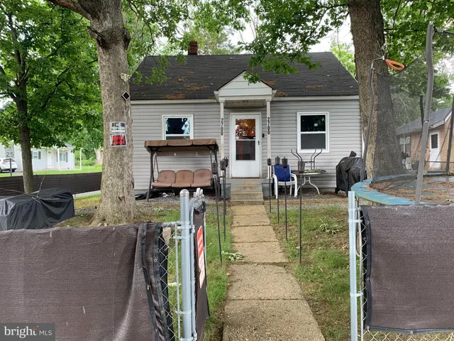 a view of a house with a backyard and a patio