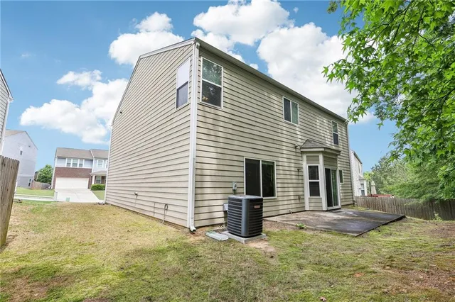 a view of a house with backyard and sitting area