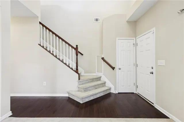 a view of entryway and hall with wooden floor