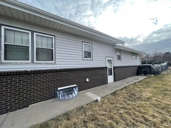 a yellow and white house with a outdoor space