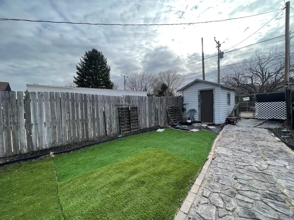 a view of a garden with a wooden fence