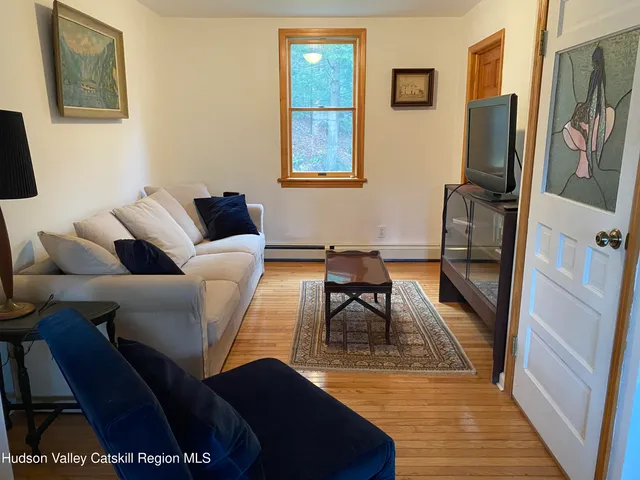 a living room with furniture fireplace and a flat screen tv