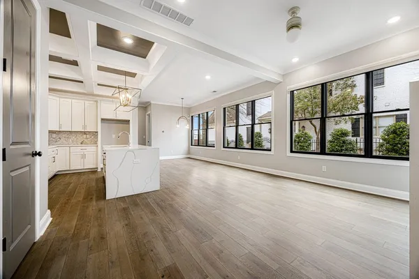 a view of large open kitchen with wooden floor and windows