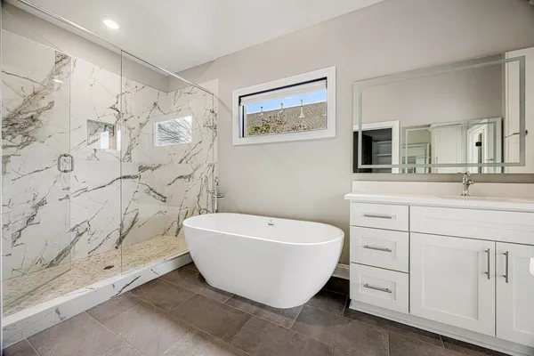a bathroom with a double vanity sink a toilet and a shower