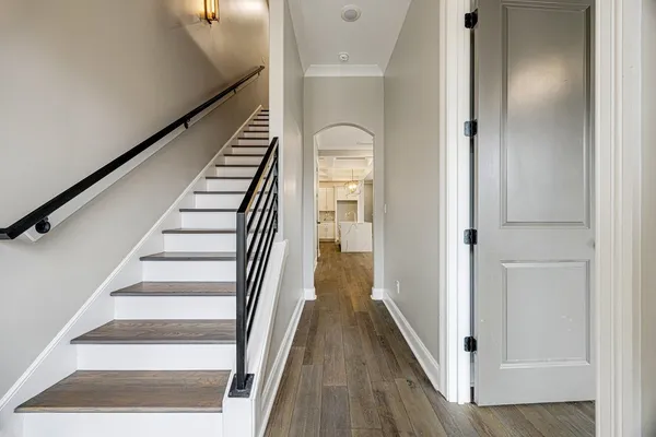 a view of a hallway with wooden floor and entryway