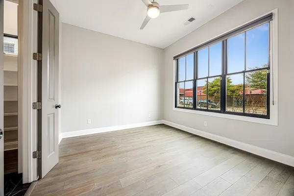 a view of a small space with wooden floor and a window