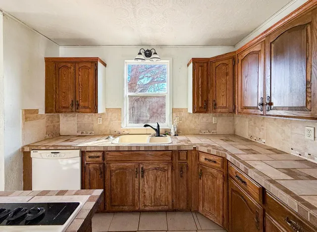 an empty room with fan and windows