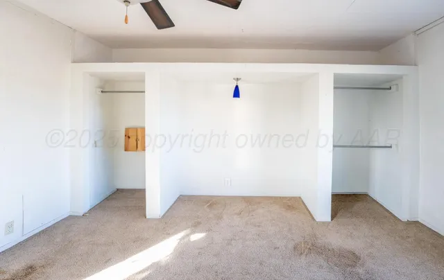 a bedroom with a bed window and a flat screen tv