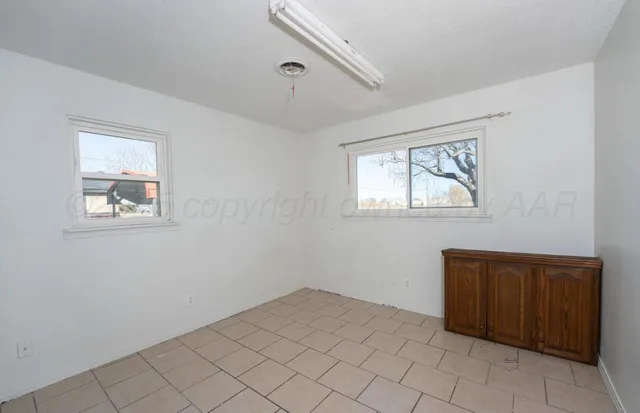 a bedroom with bed and a potted plant