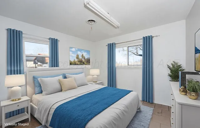 a view of a livingroom with workspace and a window