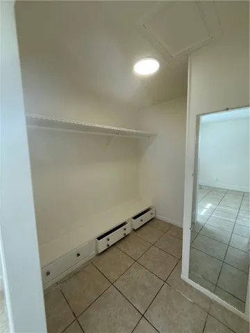 an empty room with windows and entrance