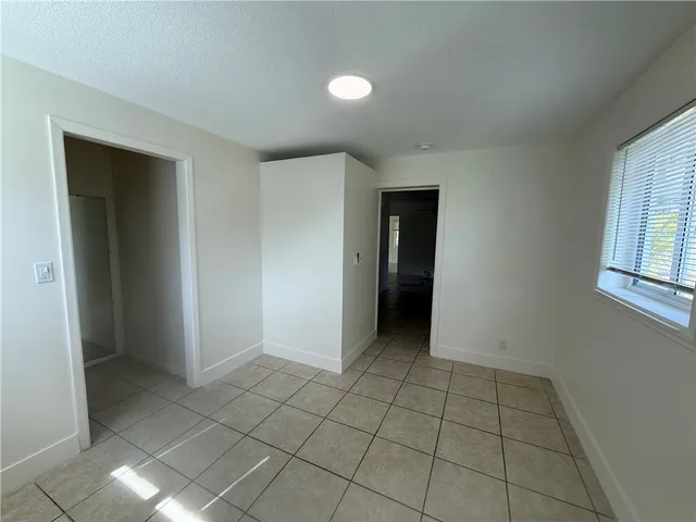 a kitchen with granite countertop a stove a sink and a refrigerator