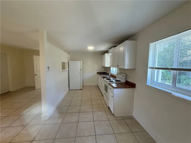 a kitchen with a stove sink and a refrigerator
