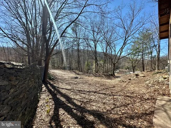 a view of yard with wooden fence