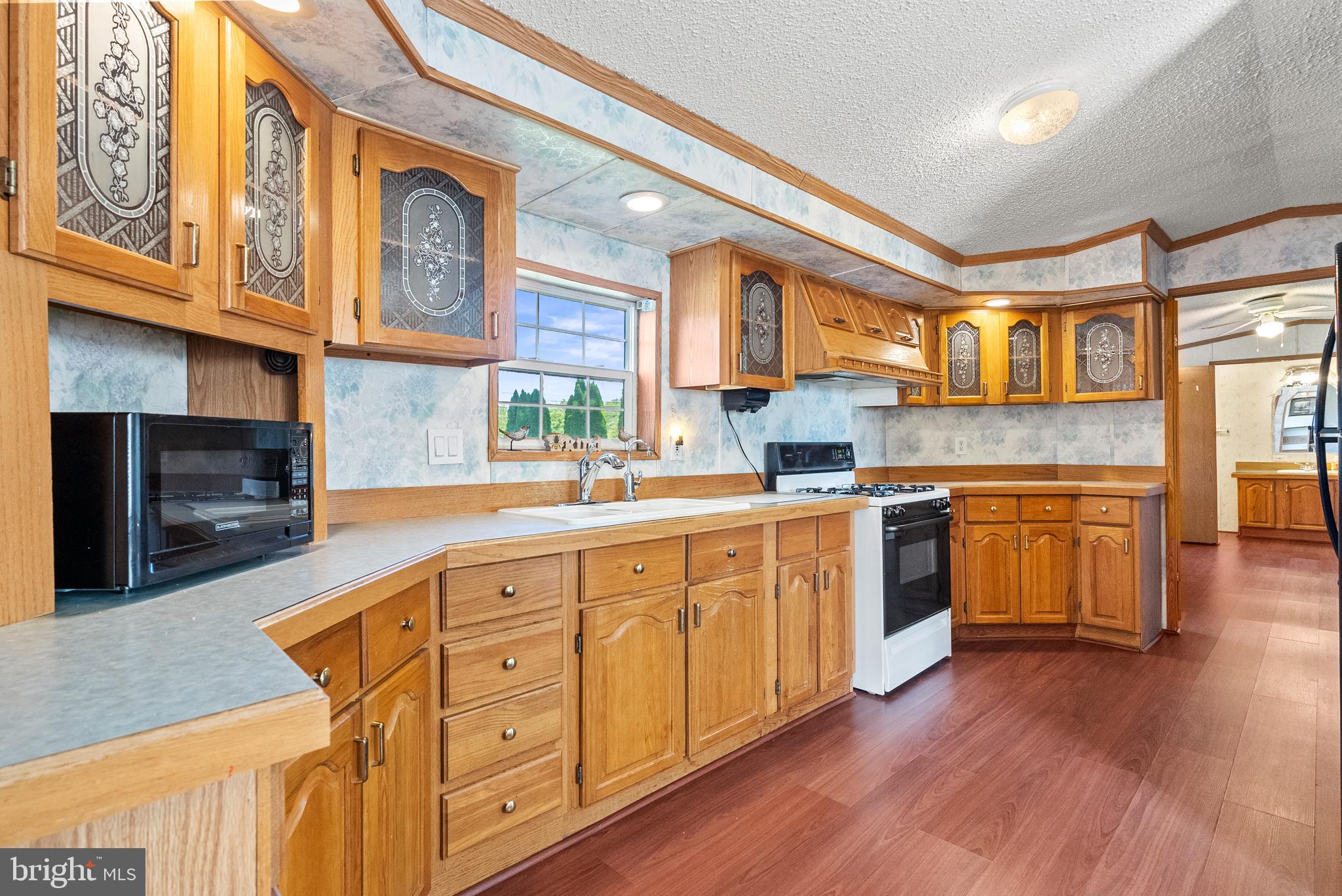 334 Ridge Road Spring City, PA 19475 - Photo 12 of 34 a kitchen with stainless steel appliances granite countertop a sink a stove cabinets and wooden floor