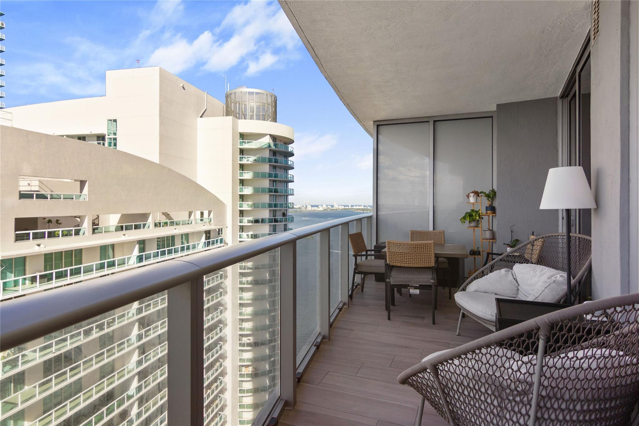 488 Northeast 18th Street, Unit 3503 Miami, FL 33132 - Photo 11 of 16 a balcony with chairs and wooden floor