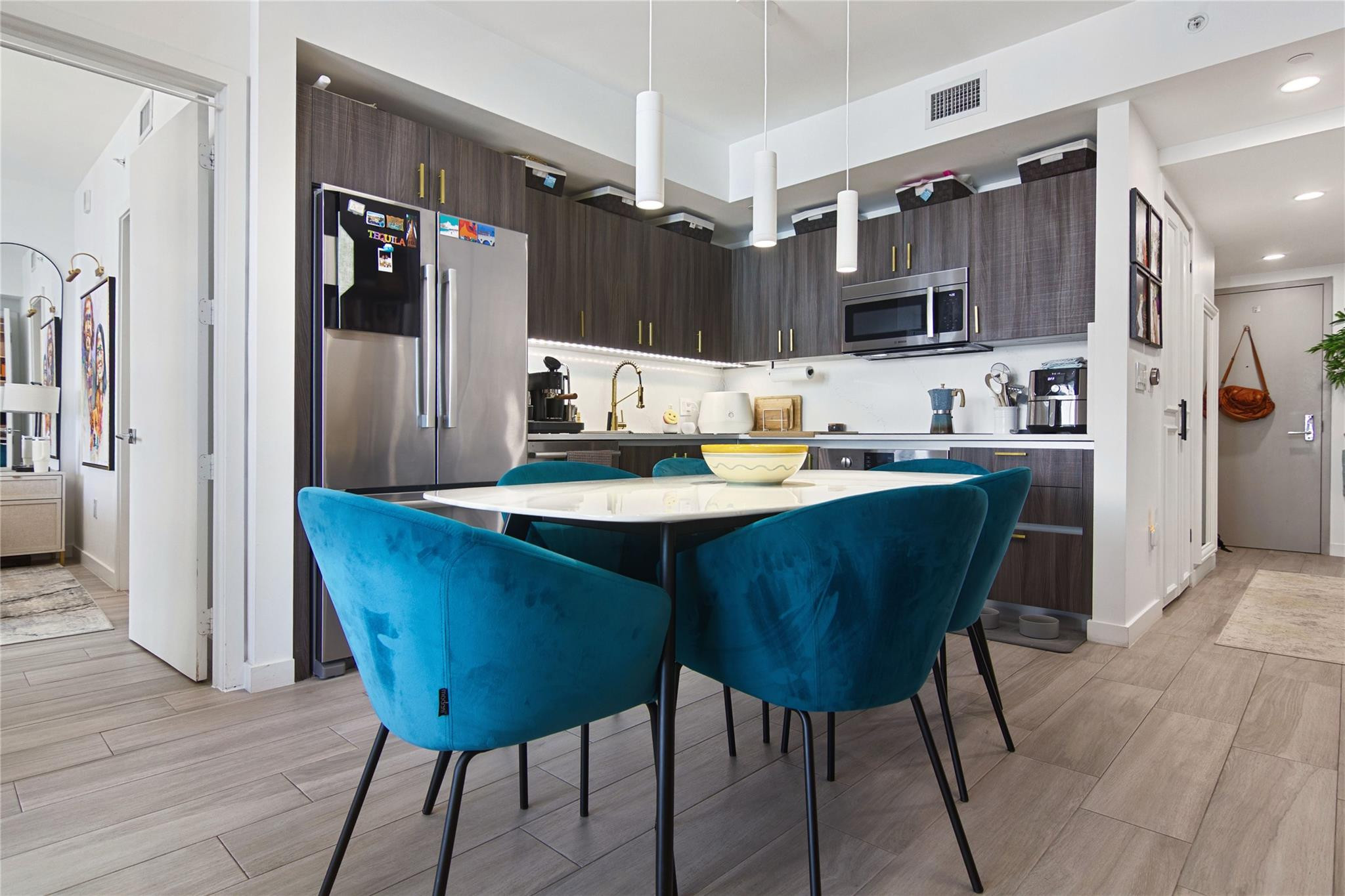 488 Northeast 18th Street, Unit 3503 Miami, FL 33132 - Photo 2 of 16 a kitchen with a dining table and chairs