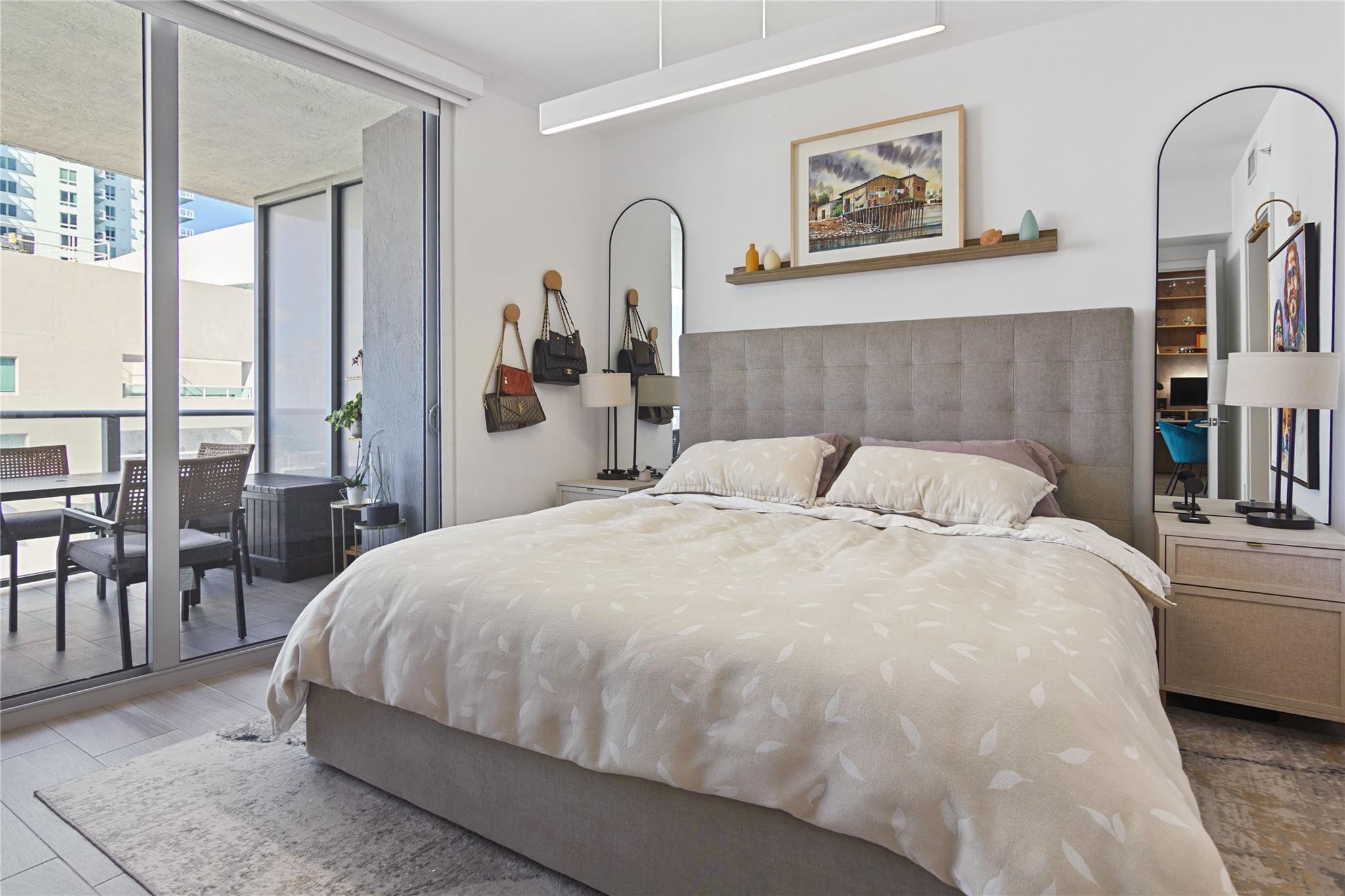 488 Northeast 18th Street, Unit 3503 Miami, FL 33132 - Photo 6 of 16 a bedroom with a large bed and a table