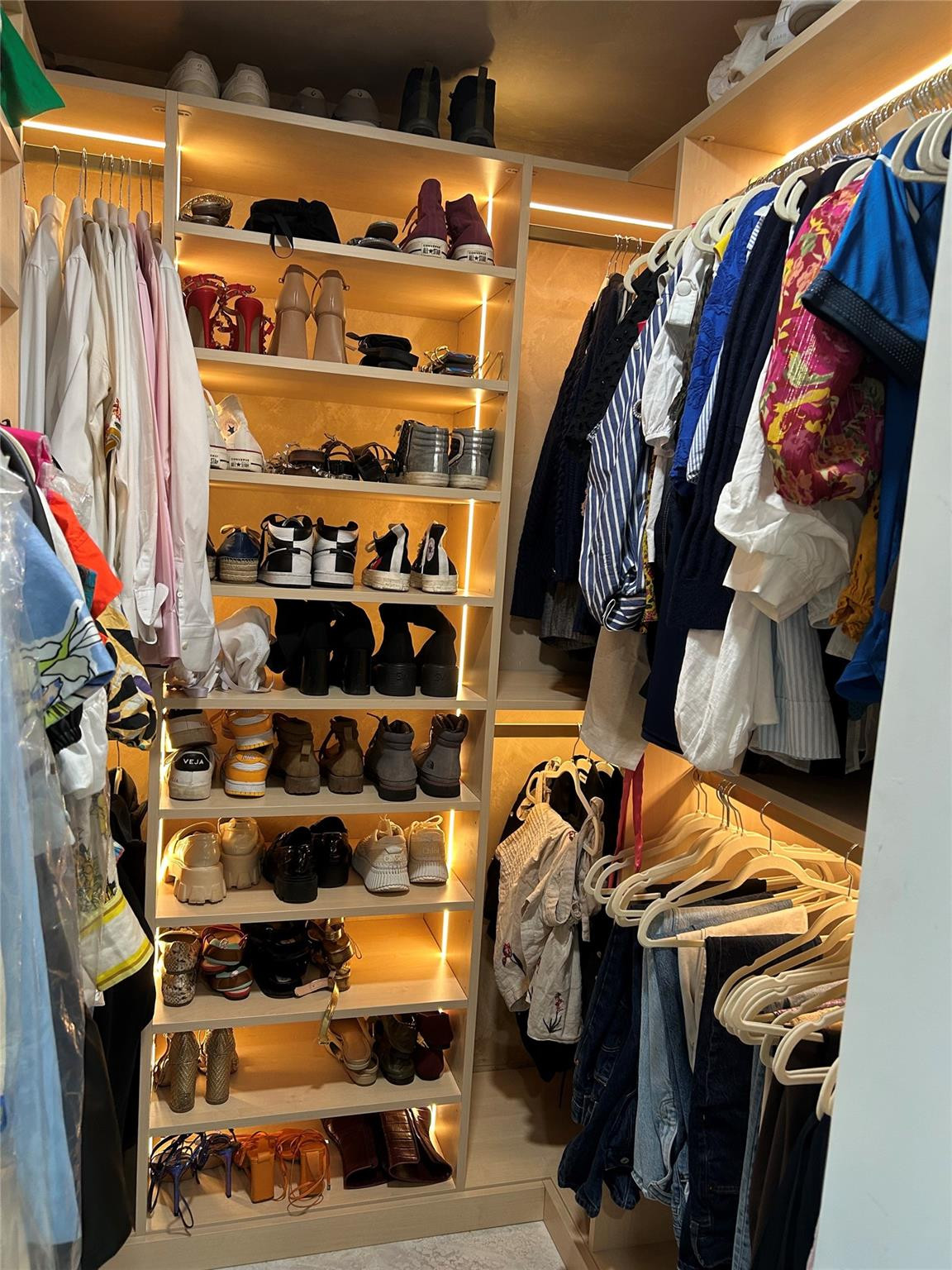 488 Northeast 18th Street, Unit 3503 Miami, FL 33132 - Photo 7 of 16 a view of walk in closet with clothes and shoes