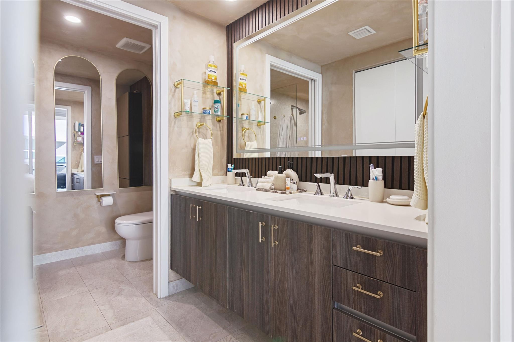 488 Northeast 18th Street, Unit 3503 Miami, FL 33132 - Photo 9 of 16 a bathroom with a double vanity sink toilet and a mirror