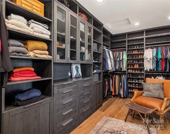 a view of walk in closet with clothes and shoes