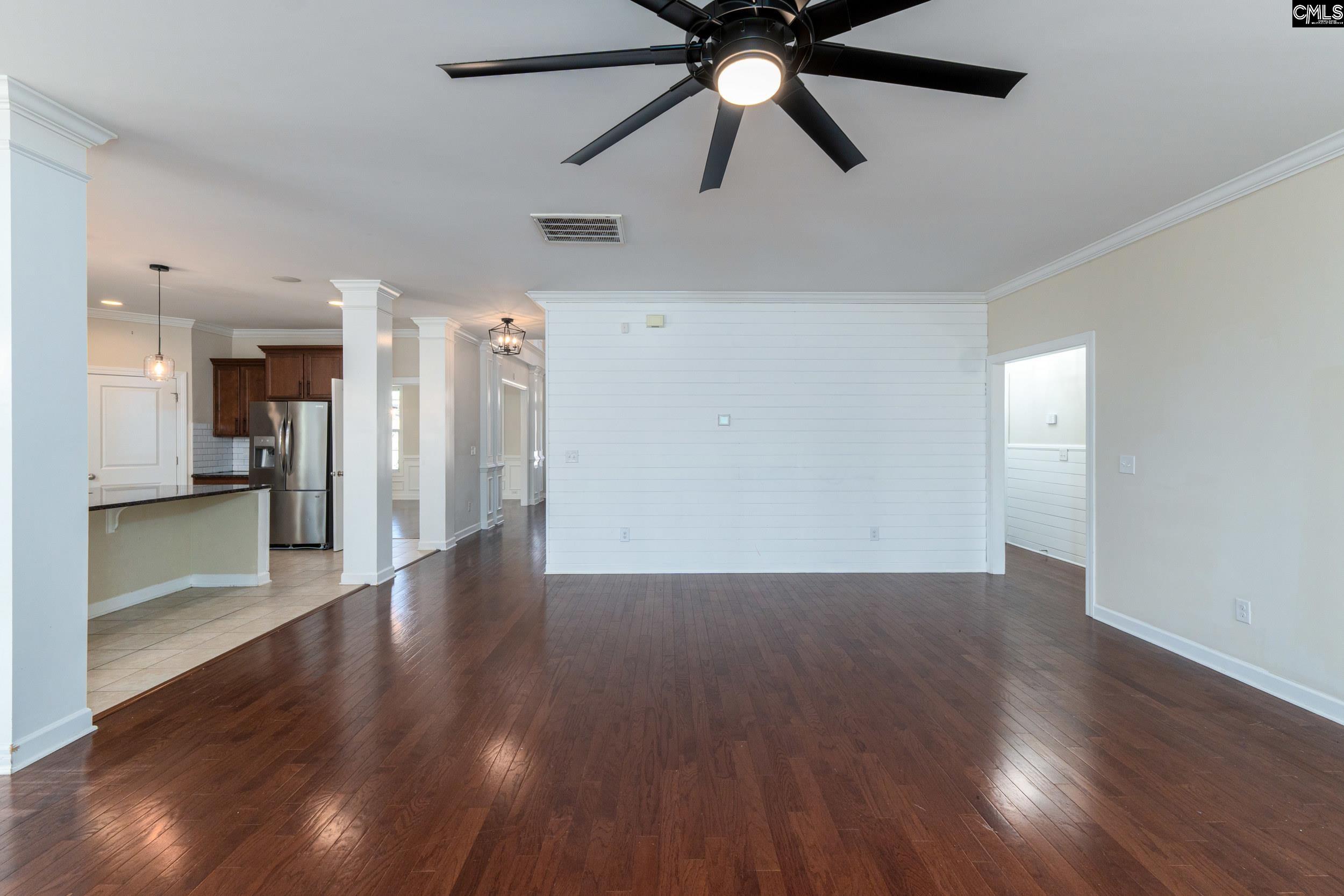 40 Wading Bird Loop Blythewood, SC 29016 - Photo 7 of 26 an empty room with wooden floor and a ceiling fan