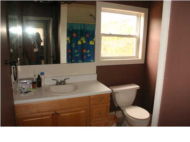461 Bay Grove Road Freeport, FL 32439 - Photo 17 of 18 a bathroom with a toilet sink and mirror
