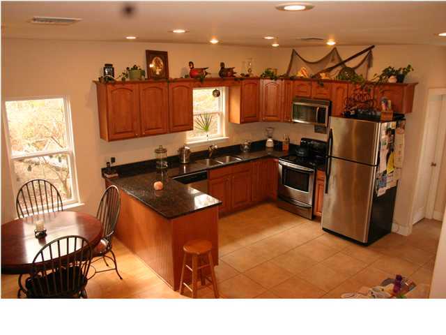 461 Bay Grove Road Freeport, FL 32439 - Photo 3 of 18 a kitchen with stainless steel appliances granite countertop a sink and a refrigerator