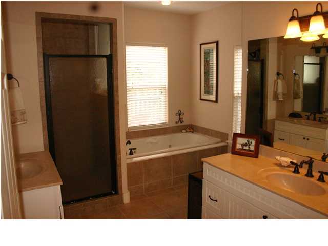 461 Bay Grove Road Freeport, FL 32439 - Photo 7 of 18 a bathroom with a sink vanity granite tub and a mirror