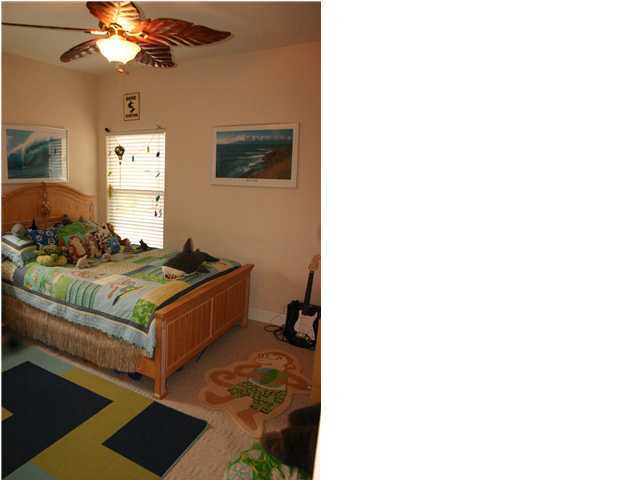 461 Bay Grove Road Freeport, FL 32439 - Photo 9 of 18 a living room with a bed and a chandelier
