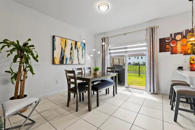 a view of a dining room with furniture and a potted plant