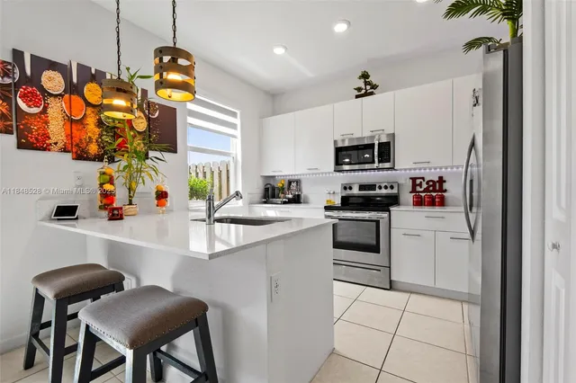 a kitchen with a sink appliances and cabinets