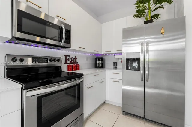 a kitchen with cabinets and stainless steel appliances