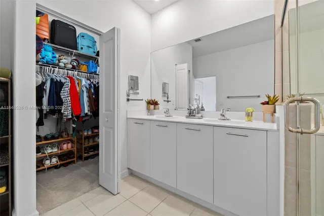 a view of walk in closet with clothes