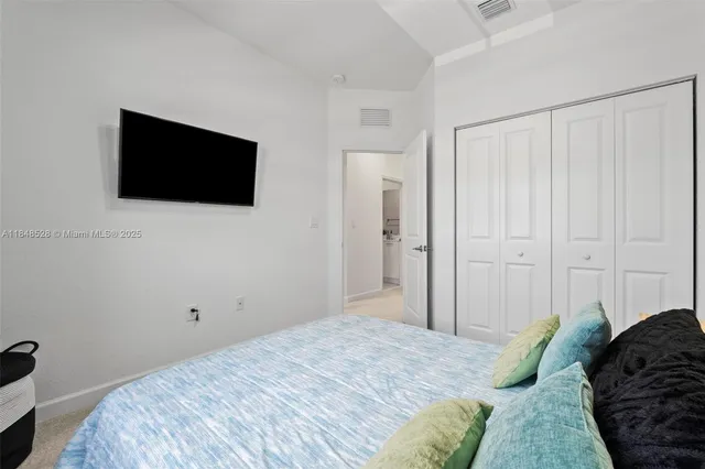 a bedroom with a bed and a flat screen tv