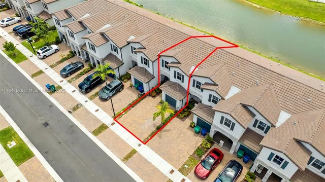 a view of a white house with a yard