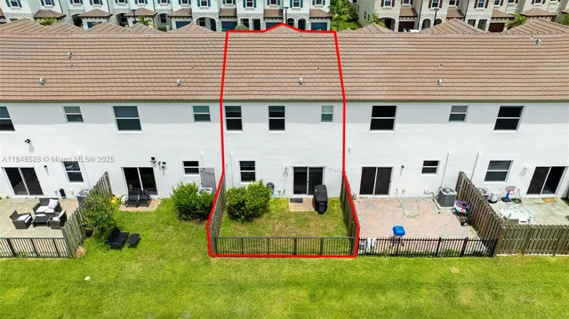 a view of a large building with garden and plants