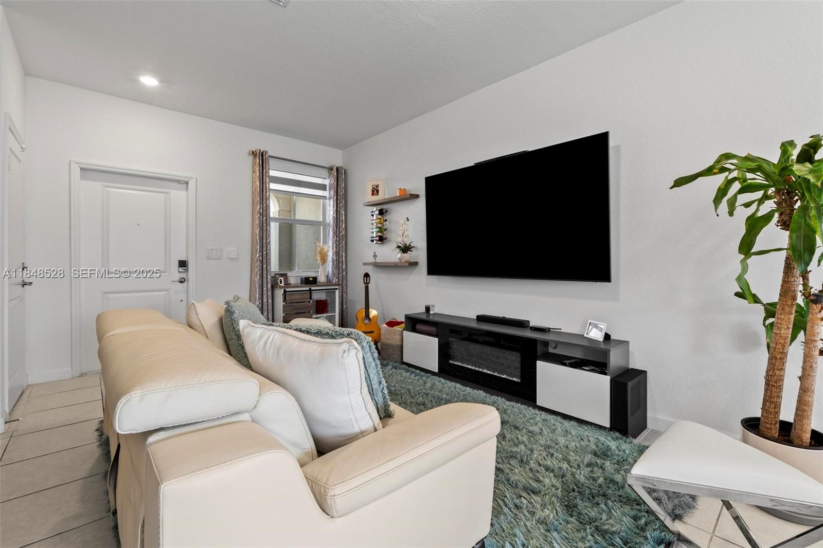 12625 Northwest 23rd Place Miami, FL 33167 - Photo 7 of 41 a living room with furniture and a flat screen tv