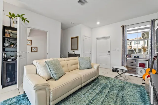 a living room with furniture and a large window