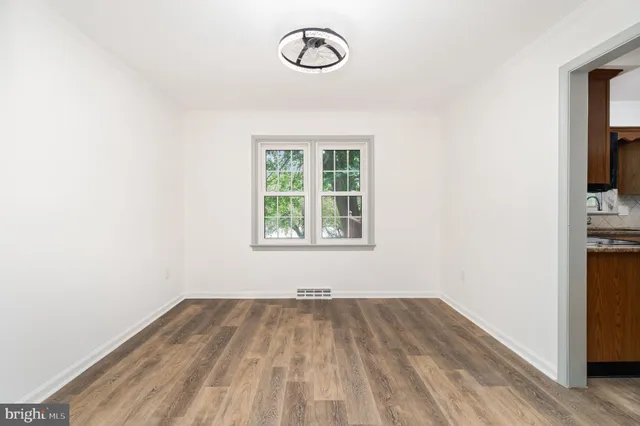 a view of a room with wooden floor and window