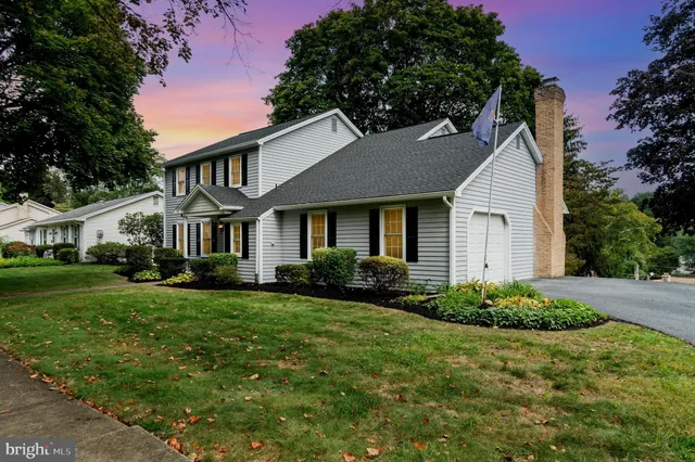 a front view of a house with a yard and porch