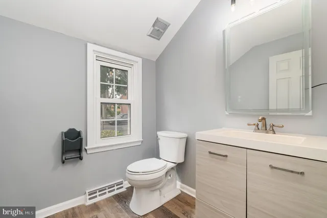 a white toilet sitting next to a bathroom sink