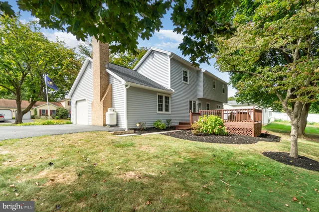 a house that has a tree in front of the house